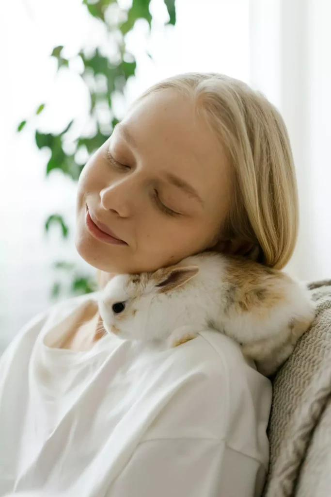 Girl with small white rabbit on her shoulder