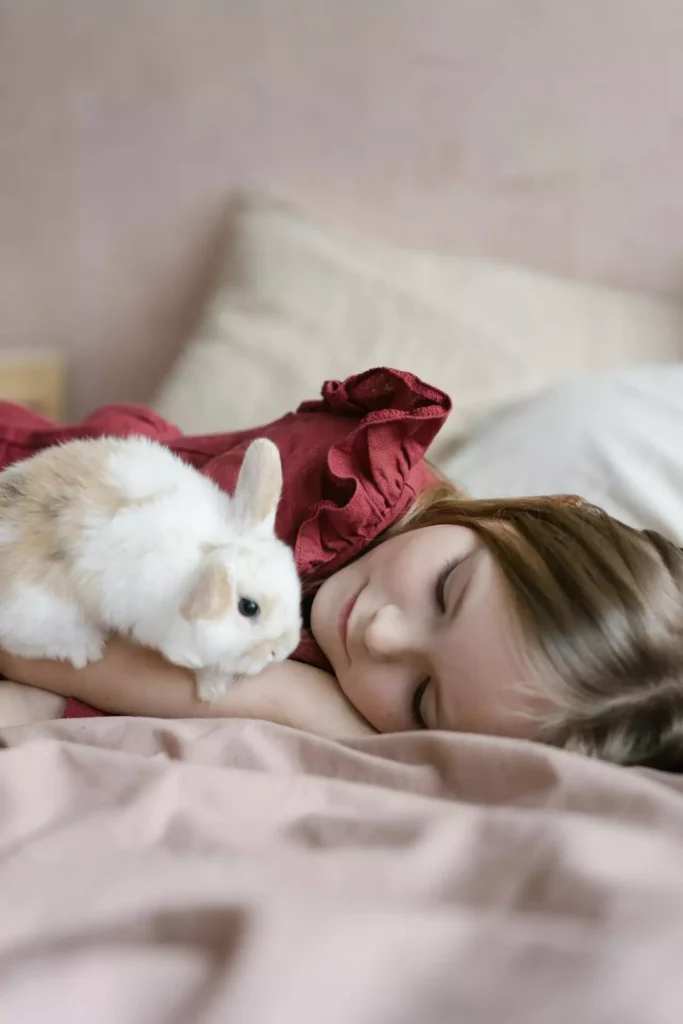 White rabbit watching a girl sleep